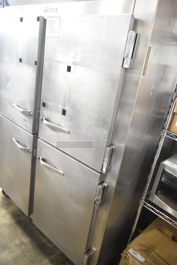 Traulsen commercial 4 half-size door reach-in fridge on casters, stainless steel, minor surface wear, visible branding on top.