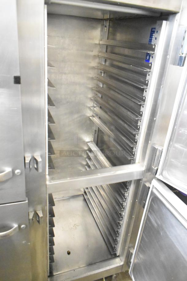 Traulsen commercial reach-in fridge with four half-size doors, stainless steel interior, on commercial casters, well-maintained.