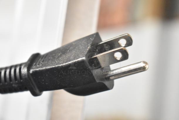 Close-up of a black power plug for an Avanti MT116V4M countertop microwave oven.