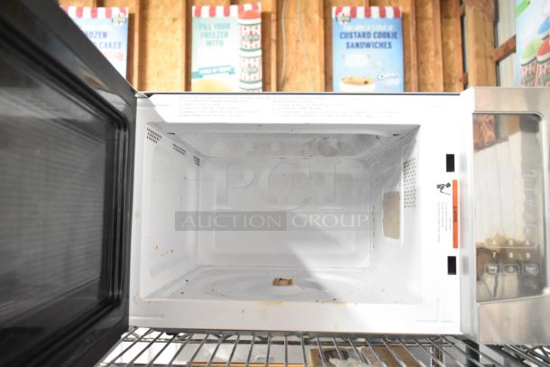 Avanti MT116V4M countertop microwave oven, 120 volts, visible interior stains, digital control panel on the side.