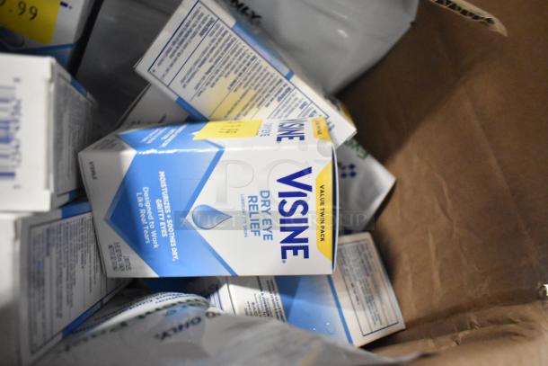 Box of various items including multiple Visine Dry Eye Relief packs. Shows packaging with moisturizing claim.