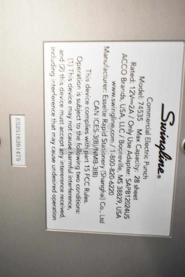 Swingline 535 silver-platinum commercial electric 3-hole punch, 28 sheet capacity, model 74535, 9/32" holes, label shown.