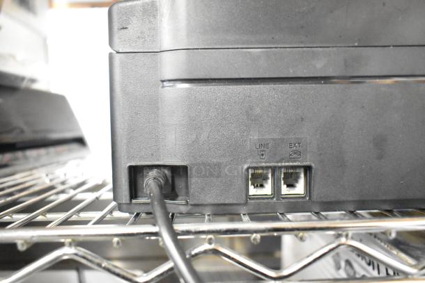 Brother MFC-J1170DW printer back view with visible phone line and extension ports, showing a cable connected in good condition.