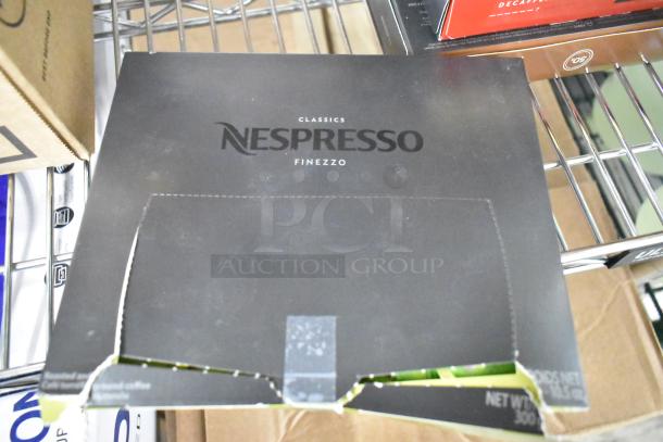 Box of Nespresso Classics Finezzo coffee capsules on a metal shelf; box is open with torn edges, revealing contents.