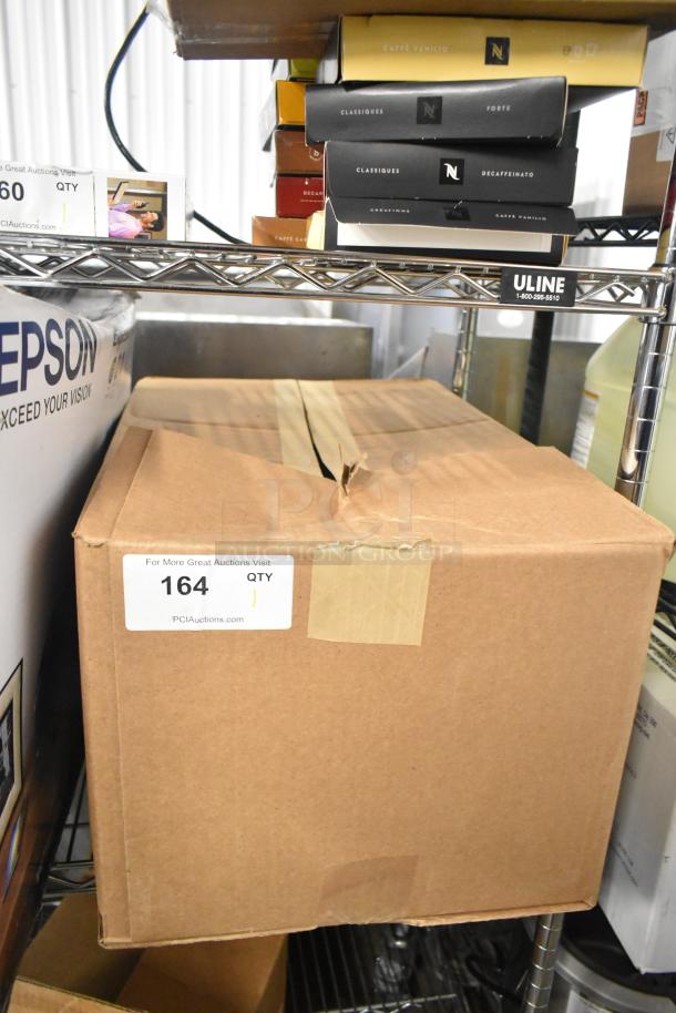 Box labeled "164" containing Rubbermaid Enriched Foam Lotion Soap Bags, sealed with tape, on metal shelf.