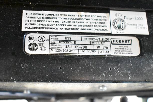 2017 Hobart HTi-7LH26 metal commercial scale label; model, serial number, voltage info visible; no power cord included.