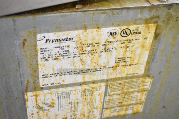 Frymaster FMRE217SC deep fryer label showing model, voltage, and NSF/UL listings. Worn condition with visible staining.