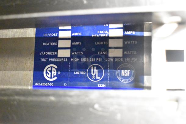 Label on Traulsen RHT 2-32NUT cooler showing CSA, UL, NSF logos, and part number 370-28587-00, indicating safety compliance.