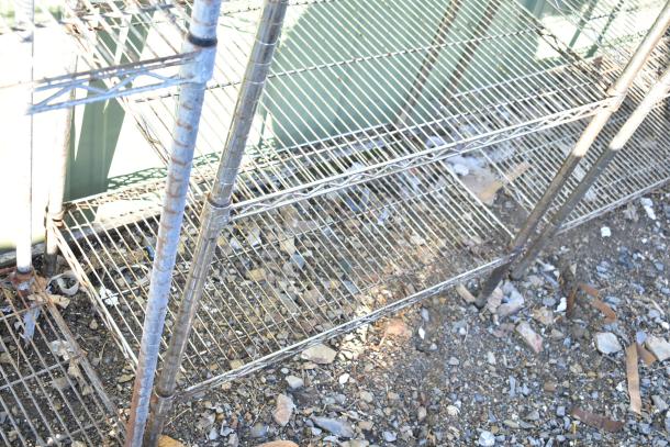 Chrome finish 4-tier wire shelving unit, outdoor condition, buyer must dismantle. Consider freight charges.