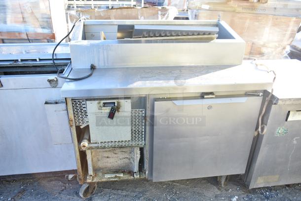 2017 Traulsen TS048HT Commercial Pizza Prep Table, with commercial casters, 115V, 1 phase. Some rust and wear visible.