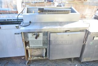 2017 Traulsen TS048HT Commercial Pizza Prep Table, with commercial casters, 115V, 1 phase. Some rust and wear visible.