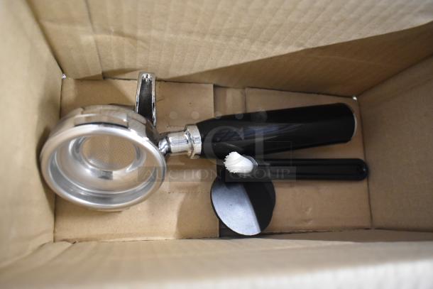 Gaggia MGV293NPU Vetro Black 3 Group Automatic Espresso Machine components in box, including portafilter and cleaning brush.