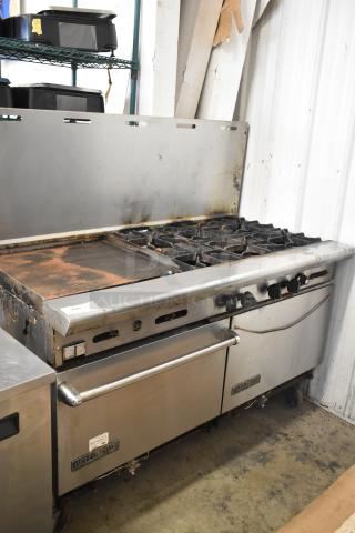American Range commercial gas 6-burner range with flat top griddle, 2 ovens, backsplash. Used condition, visible marks.