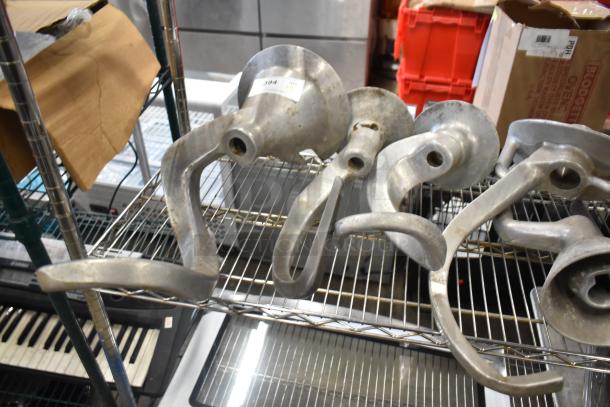 4 metal dough hooks compatible with Hobart mixer, slightly used. Durable construction, ideal for heavy-duty mixing.