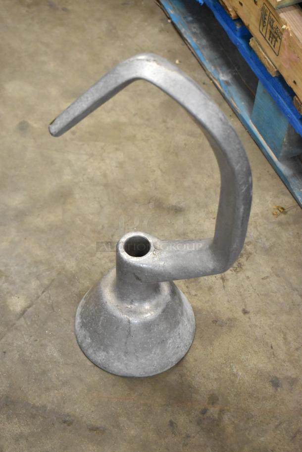 Four dough hook attachments for Hobart mixer, metal, used condition, suitable for heavy-duty dough mixing.