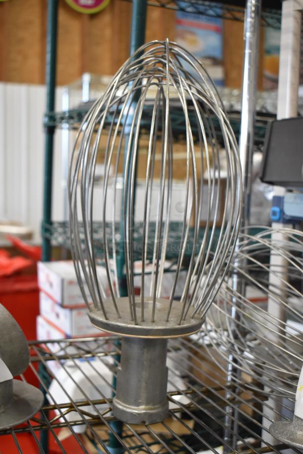 Hobart Mixer attachments: dough hook and whisk, metal construction, used condition, on a wire shelf.