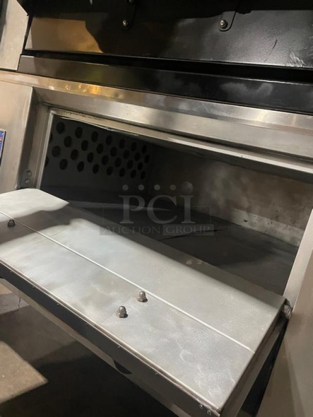 Bakers Pride FC-516/D125 stainless steel double stacked pizza/deck oven, natural gas, on legs, single phase, open front view.