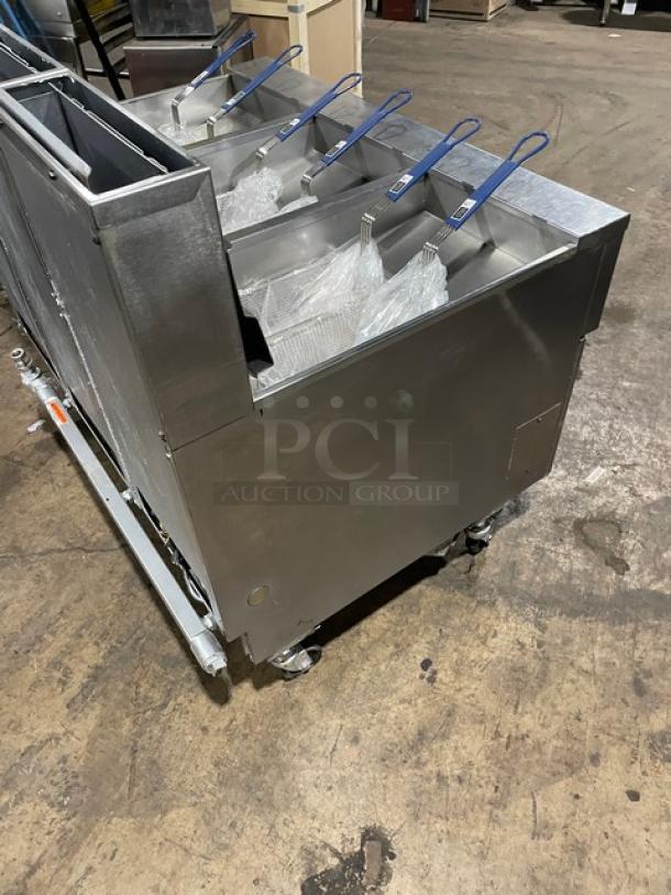 Pitco SG14JS commercial stainless steel triple-bay fryer, natural gas, digital controls, backsplash, basket hanger, on casters.