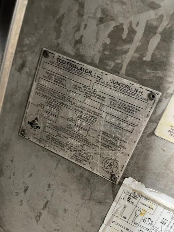 Close-up of label on Pitco Frialator SG14JS commercial fryer. Shows model, serial number G06HC035000, and specifications.