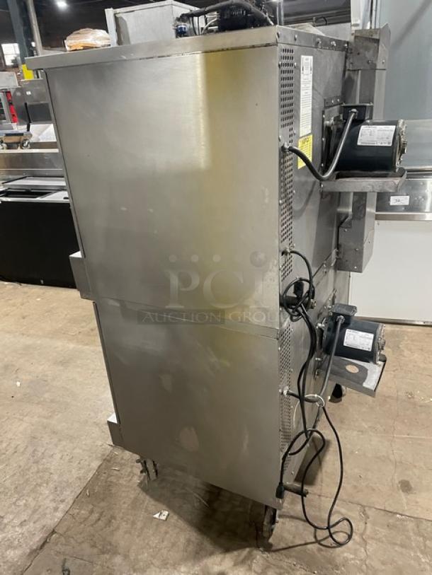 Southbend SL-Series stainless steel gas-powered double-stacked convection oven with wired oven rack, on casters.