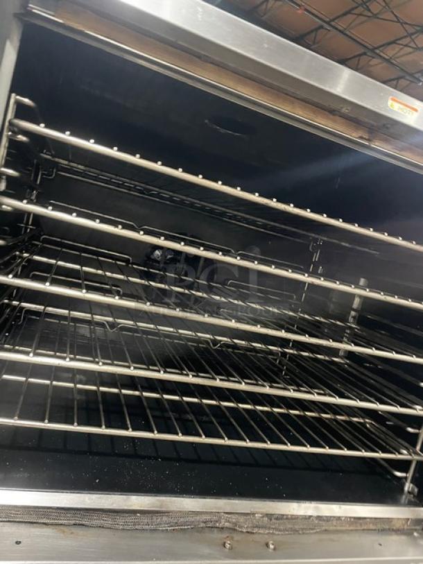 Southbend SL-Series stainless steel double-stacked convection oven with wired rack, gas-powered, on casters.