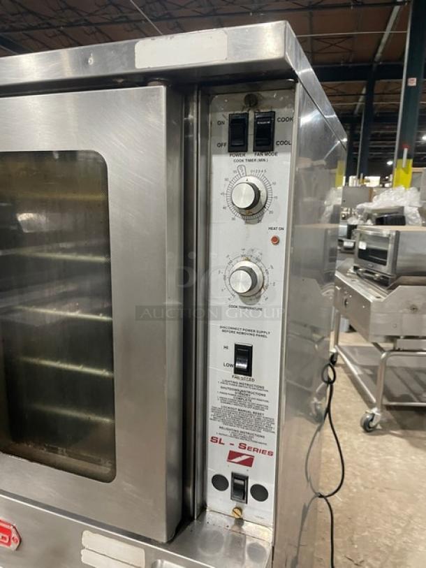 Southbend SL-Series stainless steel double-stacked gas convection oven with wired rack on casters, control panel visible.