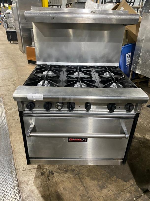 Tri-Star commercial stainless steel gas-powered range/oven combo with 6 burners, backsplash, overhead salamander shelf, and wired oven rack.