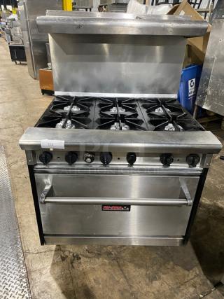 Tri-Star commercial stainless steel gas-powered range/oven combo with 6 burners, backsplash, overhead salamander shelf, and wired oven rack.