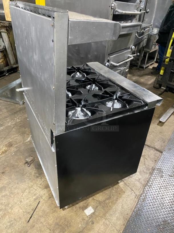 Tri-Star commercial stainless steel gas-powered 6-burner range oven combo with backsplash, overhead salamander shelf, and wired oven rack.