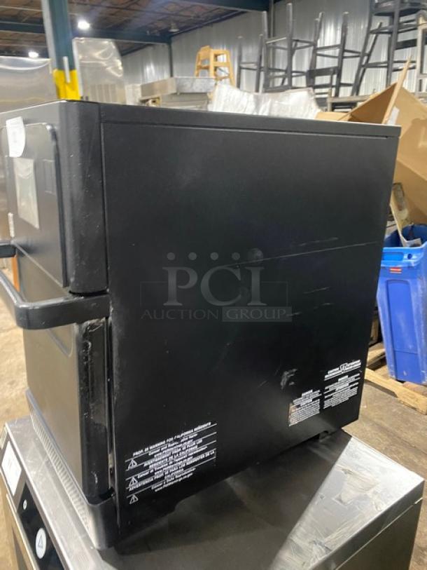 MerryChef high-speed rapid cook oven, black, electric-powered, excellent condition, with labeling on the side for model and instructions.