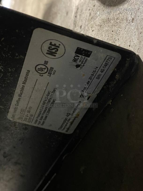 Thermoplan Mastrena CS2 espresso machine label showing model, serial number 40-148773, and certification markings.