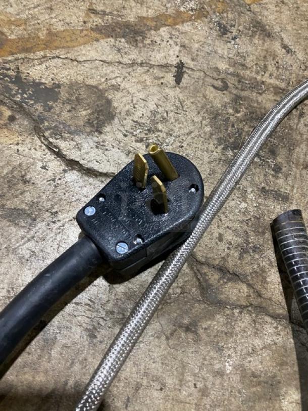 Close-up view of the electrical plug for a Thermoplan Mastrena CS2 espresso machine, showing 208V compatibility.