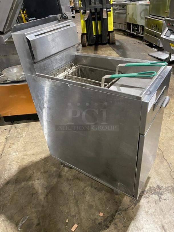 American Range commercial stainless steel deep fat fryer with back splash, basket hanger, and fry basket. Mounted on legs.