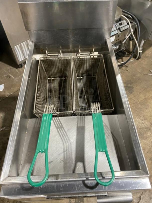 American Range commercial stainless steel gas fryer with backsplash, basket hanger, and fry baskets, on legs, in good condition.