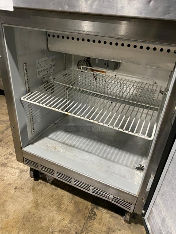 Beverage-Air SP27 stainless steel refrigerated prep table, single door, poly coated wired rack, on casters, 115V, model SN: 8108534, interior view.