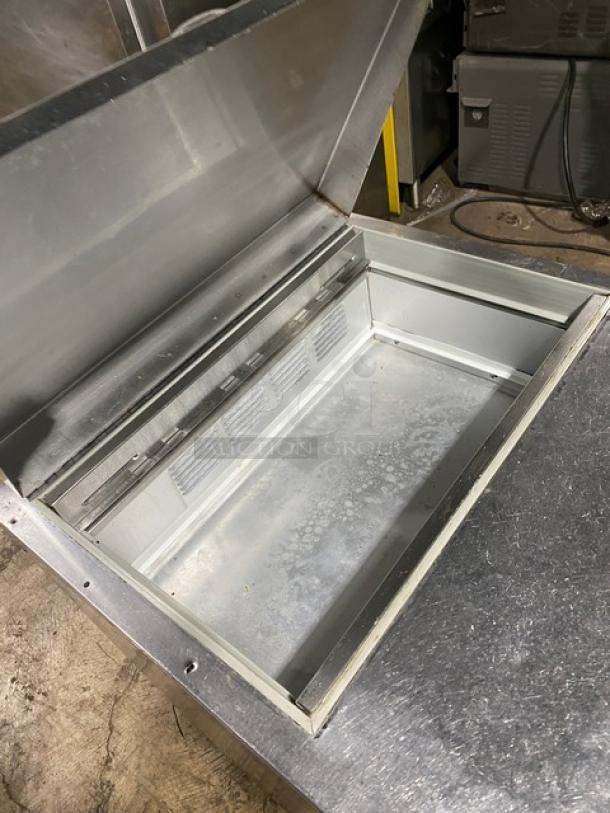 Beverage-Air SP27 refrigerated prep table, stainless steel, bain marie style, with poly-coated wire rack, on casters.