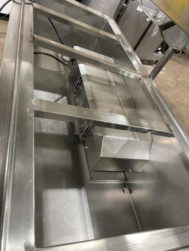 Atlas Metal commercial stainless steel 60" buffet with 4-well refrigerated salad bar, sneeze guard, tray slide, and storage cabinet. Model WCMBT4.