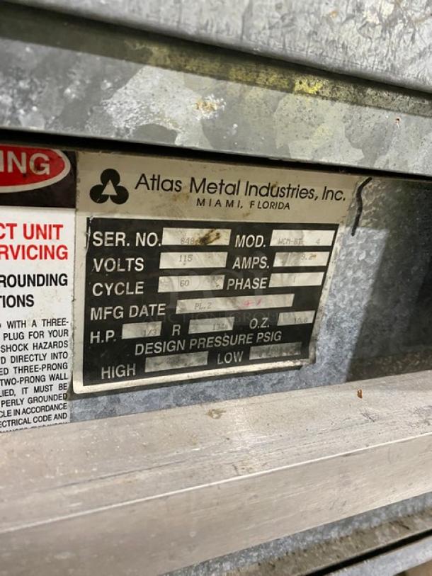 Atlas Metal WCMBT4 60" refrigerated 4-well cold food bar with sneeze guard, tray slide, dry storage cabinet, and casters.