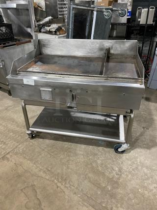 WoodStone stainless steel natural gas countertop split top plancha griddle, model WSPL48364CT00NG, with splash guards and undershelf cart.