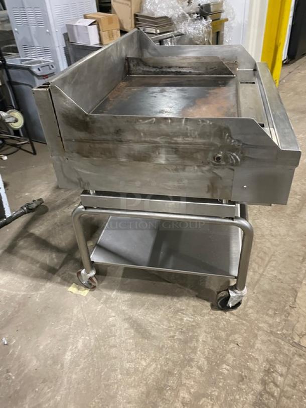 WoodStone WS-PL-4836-4-CT00NG stainless steel griddle with splash guard and undershelf, on casters. Natural gas, 120V, good condition.