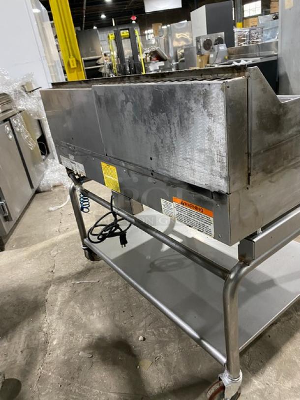 WoodStone stainless steel natural gas split top plancha griddle, model WSPL48364CT00NG, with back/side splash, on cart.