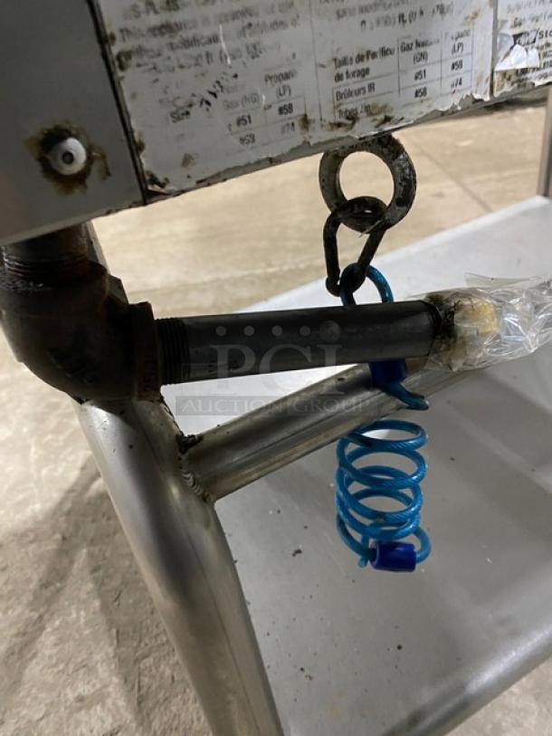 WoodStone stainless steel natural gas countertop plancha griddle, model WSPL48364CT00NG, with under-shelf cart on casters.