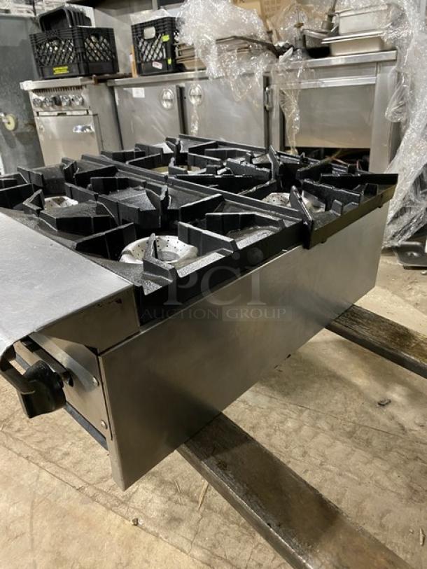 American Range commercial stainless steel gas-powered countertop 4-burner range. Durable cast iron grates. Excellent condition.