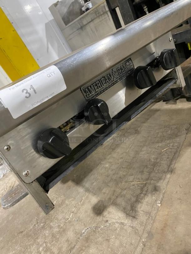 American Range commercial stainless steel gas-powered 4-burner countertop range, featuring control knobs and a visible brand label.