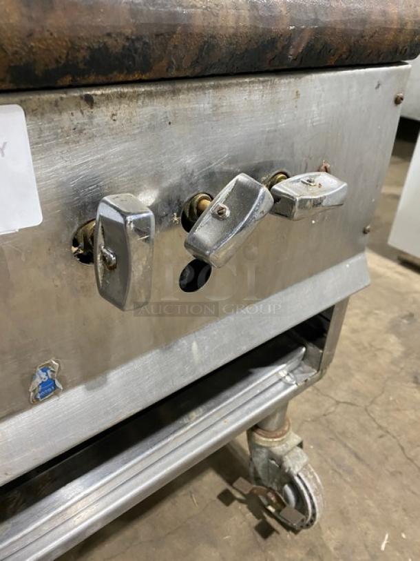 U.S. Range natural gas single burner stock pot range, stainless steel, worn condition, on casters for mobility.