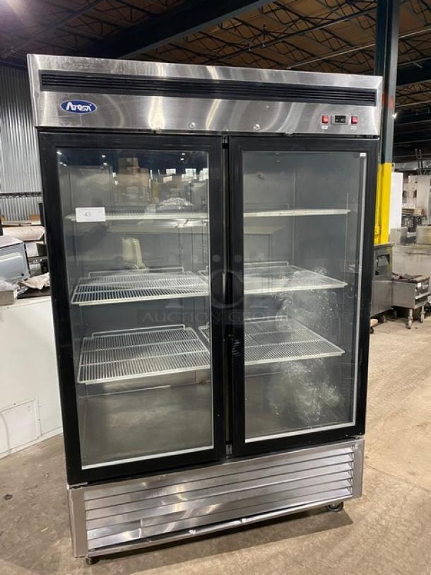 Atosa MCF8707 stainless steel double glass door refrigerator with poly coated wired racks, model SN: MCF8707150426C4009, on casters.