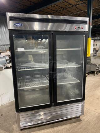 Atosa MCF8707 stainless steel double glass door refrigerator with poly coated wired racks, model SN: MCF8707150426C4009, on casters.