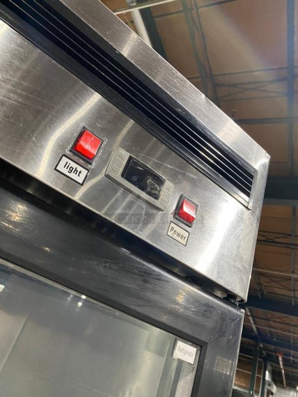 Atosa MCF8707 commercial fridge, stainless steel, double glass swing doors, poly-coated wired rack, light and power buttons shown.