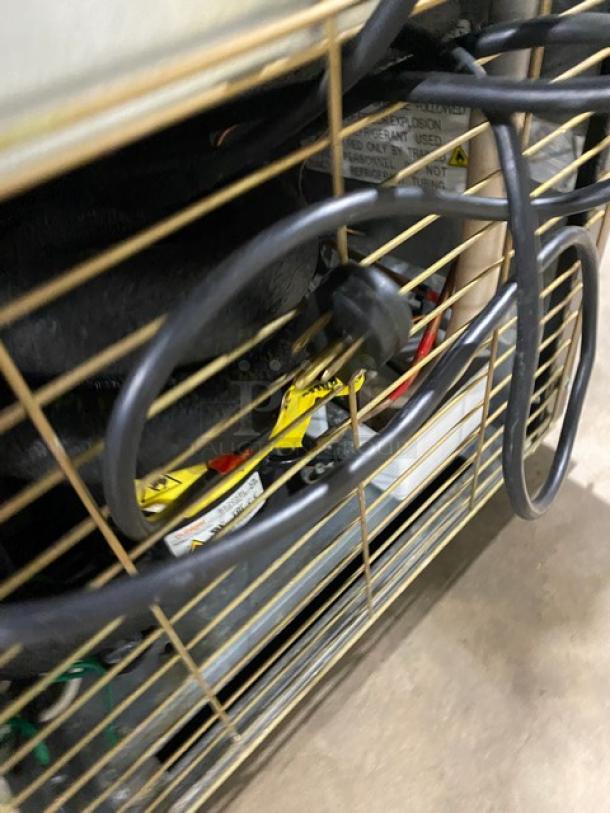 Imbrera VR08R6 merchandiser refrigerator back view, showing wiring and poly coated wired rack. Energy Star certified.