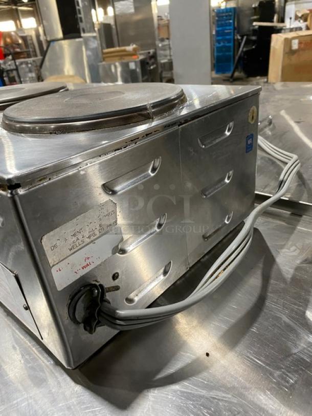 Wells Commercial 2-Burner Electric Stainless Steel Hotplate. Front-to-back design with individual controls. Visible wear.